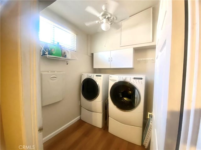 clothes washing area with cabinet space, baseboards, ceiling fan, dark wood-style flooring, and washer and dryer