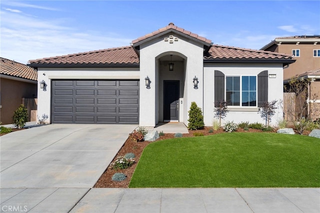 mediterranean / spanish-style house with a garage, concrete driveway, a tile roof, a front yard, and stucco siding