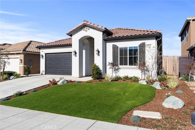 mediterranean / spanish-style house featuring a front yard, concrete driveway, an attached garage, and stucco siding