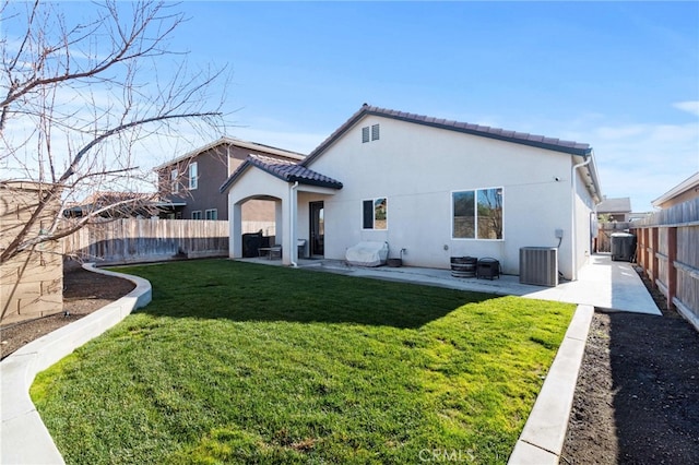 rear view of house with cooling unit, a fenced backyard, a patio, and stucco siding