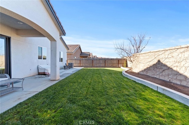 view of yard featuring a patio area, a fenced backyard, and central AC unit