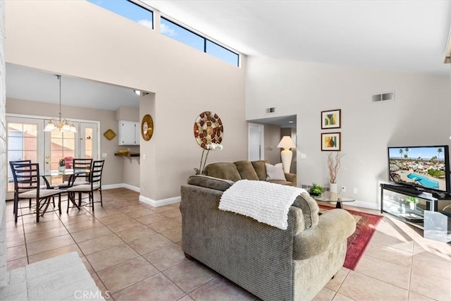 living room featuring light tile patterned floors, baseboards, visible vents, and an inviting chandelier