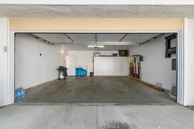 garage with visible vents and a garage door opener