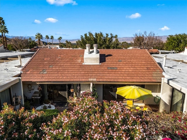 rear view of property with a mountain view