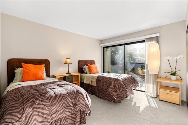 carpeted bedroom featuring access to exterior