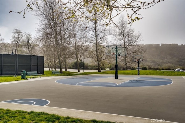 view of basketball court featuring community basketball court and fence