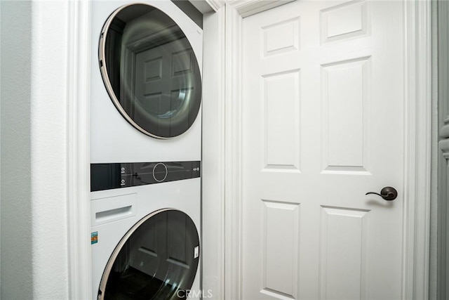 laundry room with stacked washing maching and dryer