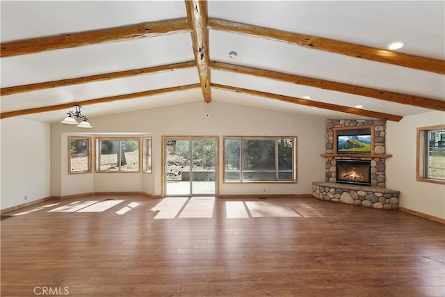 unfurnished living room featuring lofted ceiling with beams, a fireplace, baseboards, and wood finished floors