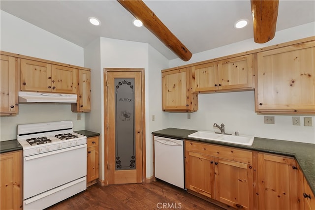 kitchen featuring dark countertops, white appliances, under cabinet range hood, and a sink