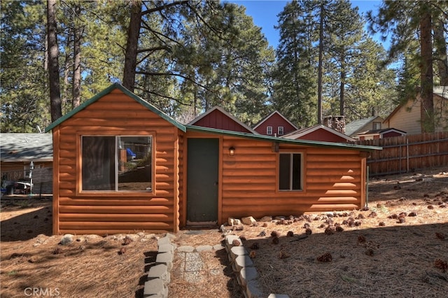 log home featuring fence