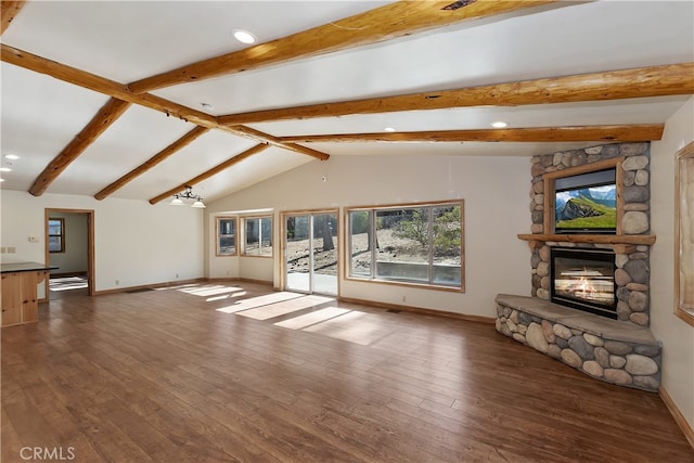 unfurnished living room featuring vaulted ceiling with beams, dark wood-type flooring, a fireplace, and baseboards