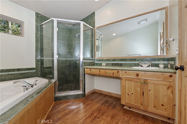 full bathroom with a garden tub, wood finished floors, visible vents, vanity, and a stall shower