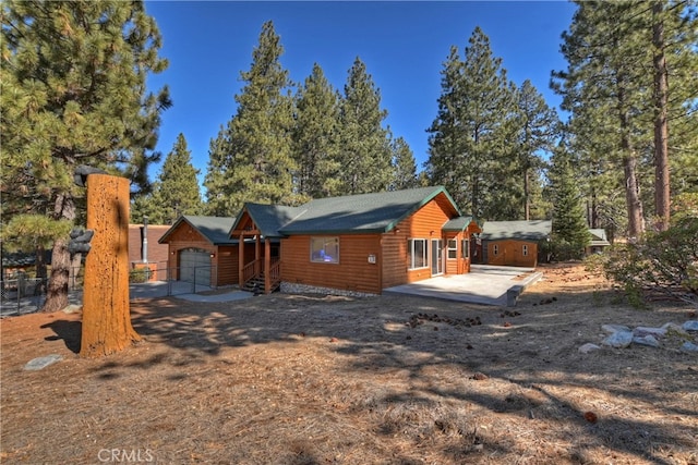 view of front of home with a patio and an attached garage