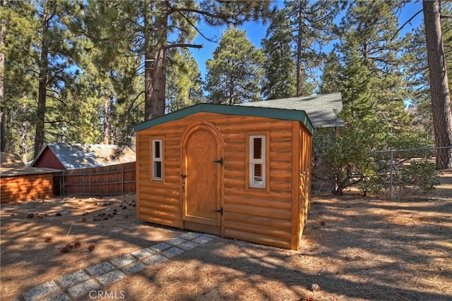 view of shed featuring fence