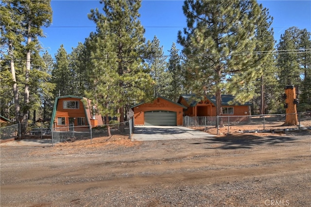 view of front of property with a fenced front yard and a detached garage