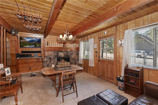 living area featuring a chandelier, a stone fireplace, wooden ceiling, wood walls, and beam ceiling