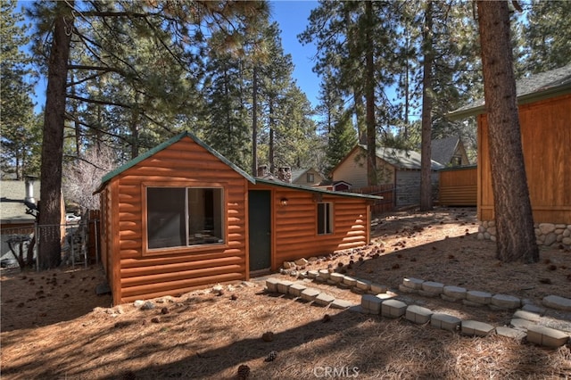 view of outbuilding featuring an outbuilding and fence