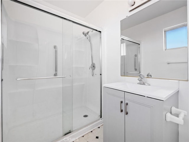 bathroom featuring a shower stall and vanity