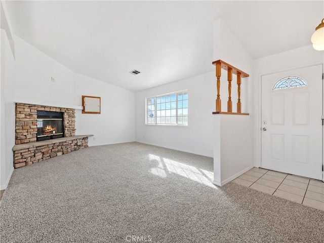 entrance foyer with light carpet, visible vents, and vaulted ceiling