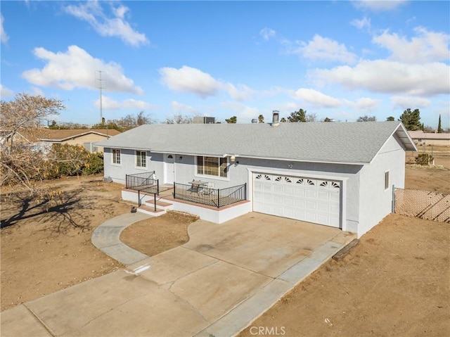 single story home with a garage, driveway, and stucco siding