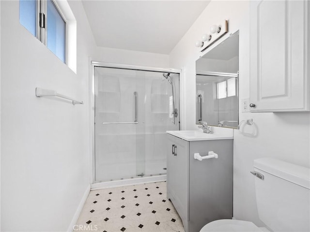 full bath with tile patterned floors, a shower stall, toilet, and vanity