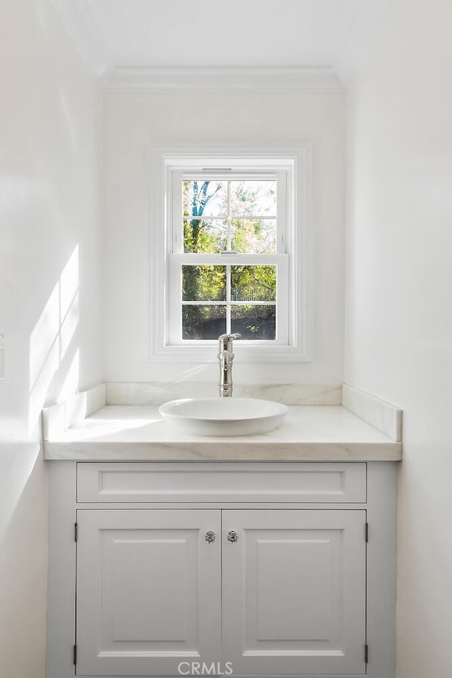 room details with crown molding and vanity