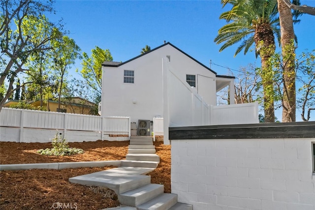 exterior space featuring fence and stucco siding