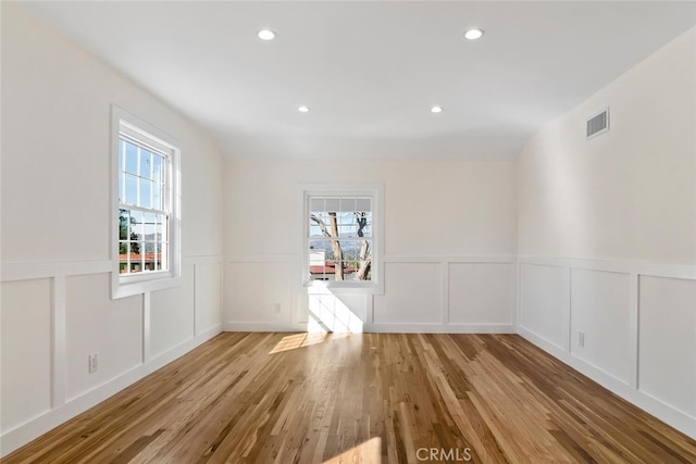 unfurnished room featuring plenty of natural light, light wood-style flooring, and recessed lighting