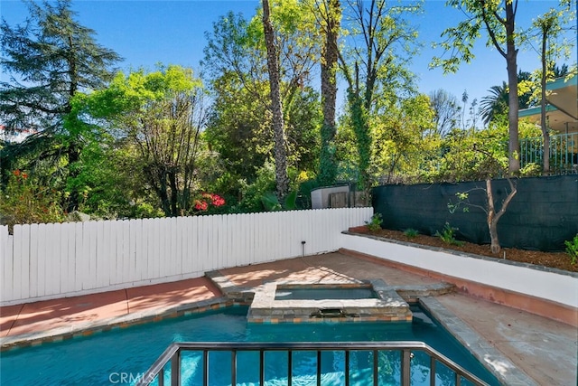 view of swimming pool featuring an in ground hot tub, a fenced backyard, and a fenced in pool