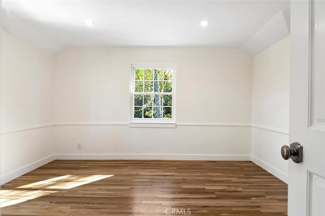 unfurnished room featuring dark wood-style floors, lofted ceiling, baseboards, and recessed lighting