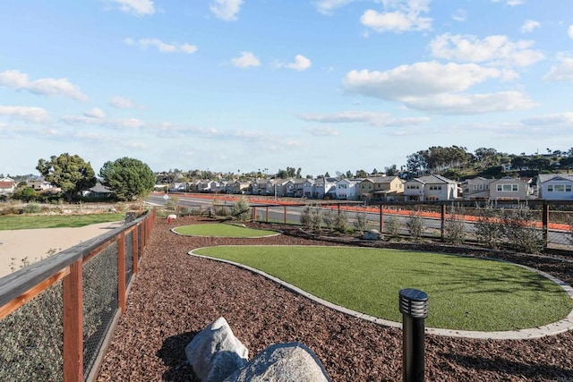 view of yard with a residential view and fence