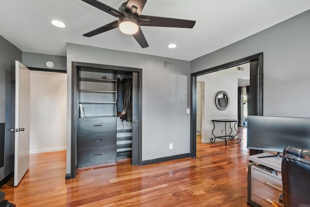 office space with recessed lighting, wood finished floors, a ceiling fan, visible vents, and baseboards