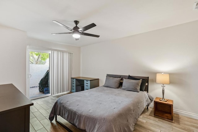 bedroom with access to exterior, a ceiling fan, visible vents, and wood tiled floor