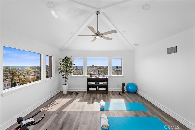 workout area with wood finished floors, visible vents, and baseboards