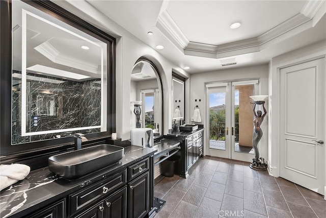 interior space with recessed lighting, vanity, ornamental molding, french doors, and a tray ceiling