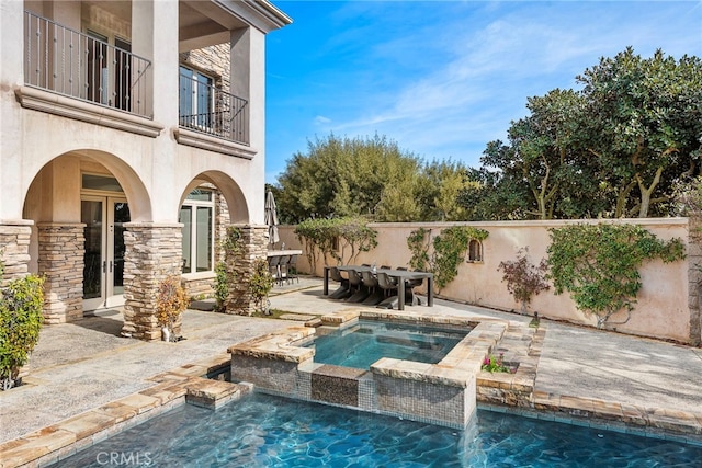 view of pool featuring a fenced in pool, french doors, a patio area, an in ground hot tub, and a fenced backyard