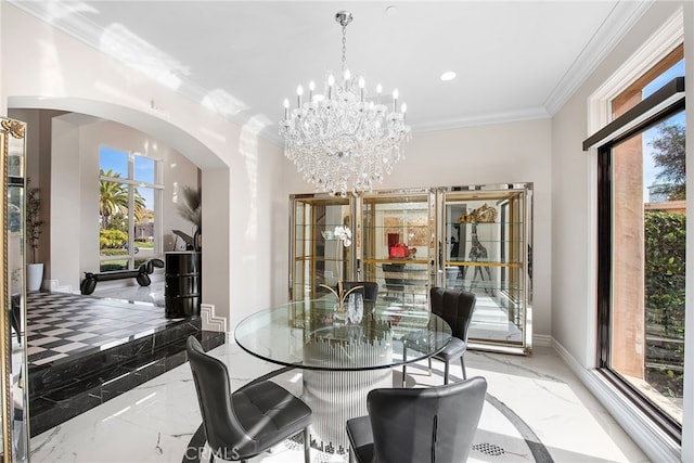 dining space with marble finish floor, baseboards, arched walkways, and ornamental molding