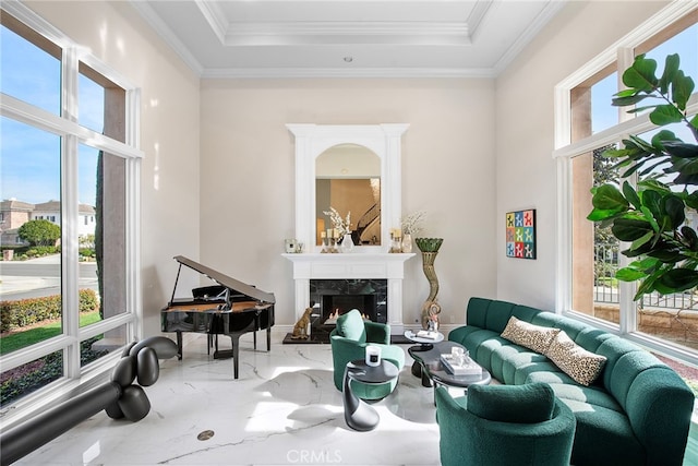 sitting room with marble finish floor, a raised ceiling, crown molding, and a premium fireplace