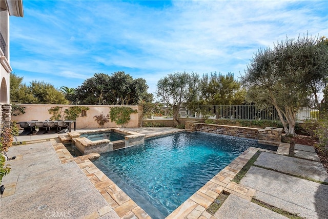 view of swimming pool with a patio area, a fenced backyard, and a pool with connected hot tub