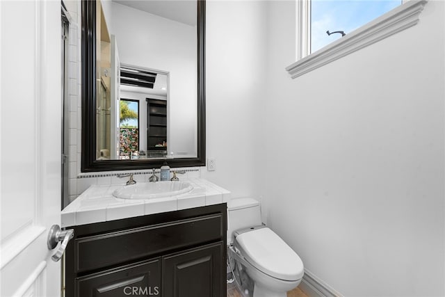 bathroom with vanity and toilet