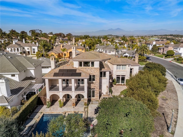 drone / aerial view featuring a mountain view and a residential view