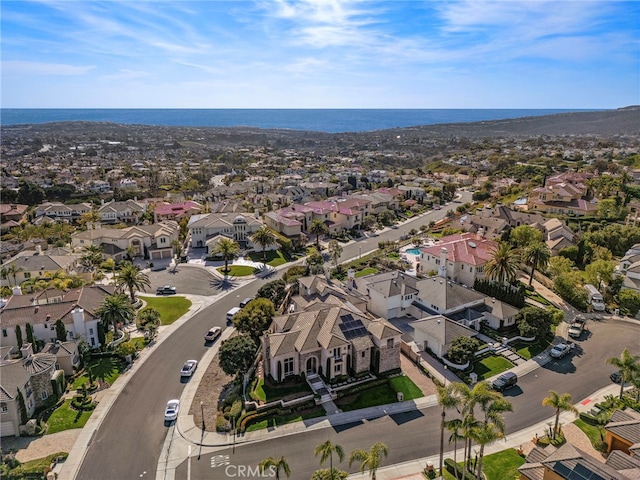 drone / aerial view featuring a residential view and a water view