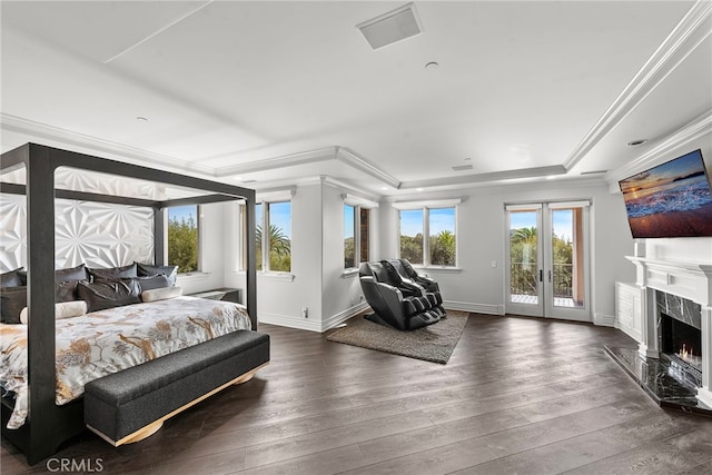 bedroom featuring a premium fireplace, ornamental molding, wood finished floors, access to outside, and french doors