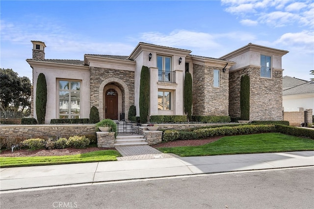 view of front of house with stone siding, a chimney, and stucco siding