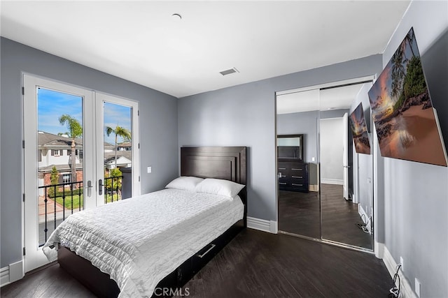 bedroom featuring dark wood-type flooring, visible vents, baseboards, access to exterior, and french doors