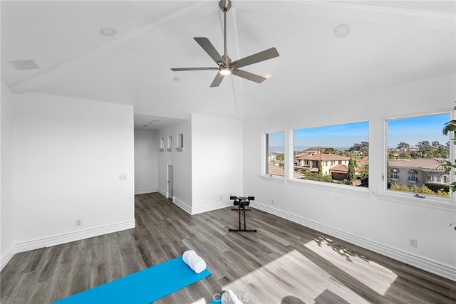 exercise room with high vaulted ceiling, ceiling fan, baseboards, and wood finished floors