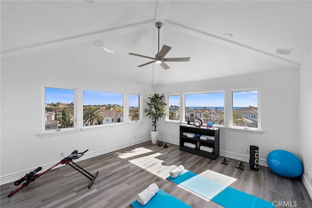 workout room featuring vaulted ceiling, wood finished floors, visible vents, and baseboards