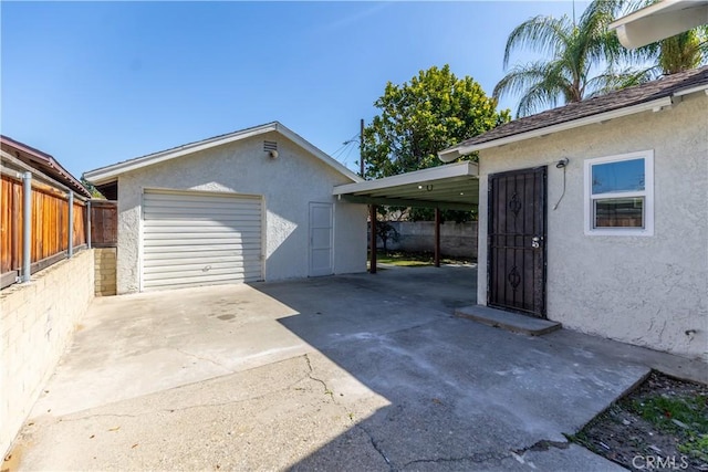 detached garage with driveway and fence