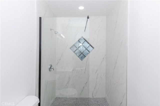 full bathroom with toilet, a marble finish shower, and recessed lighting