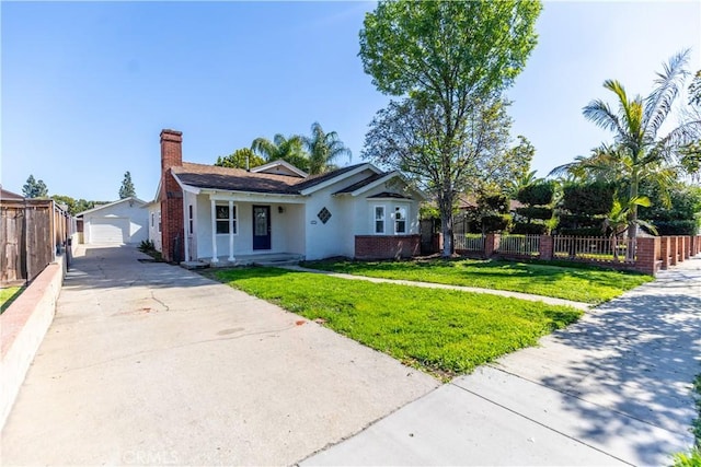 view of front of house featuring a front yard, fence private yard, a chimney, and brick siding